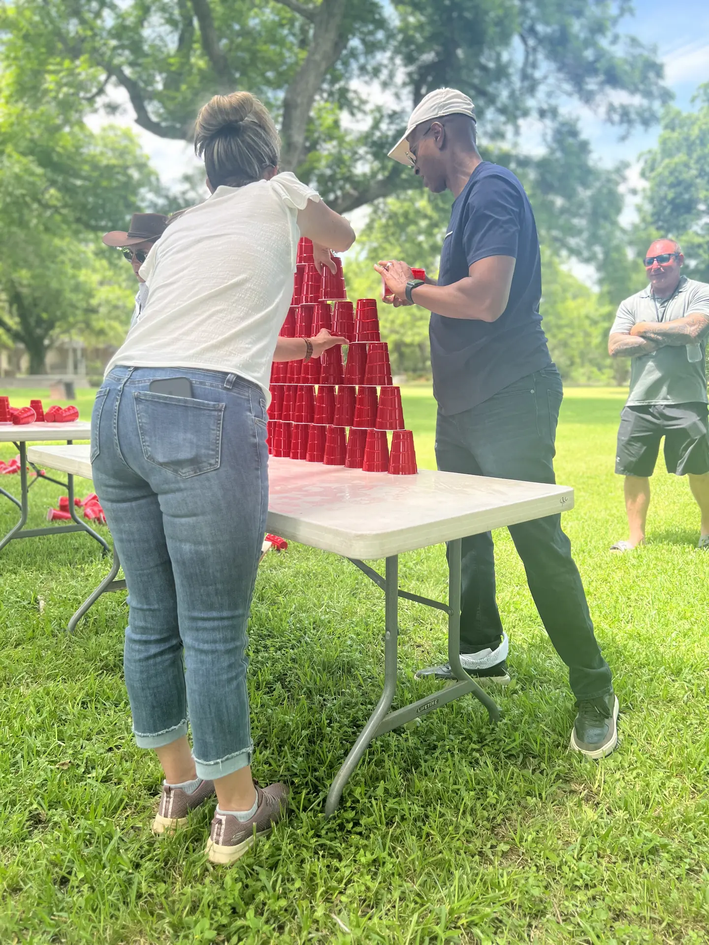 Coworkers playing a cup-stacking game at a corporate picnic at Rio Cibolo Ranch