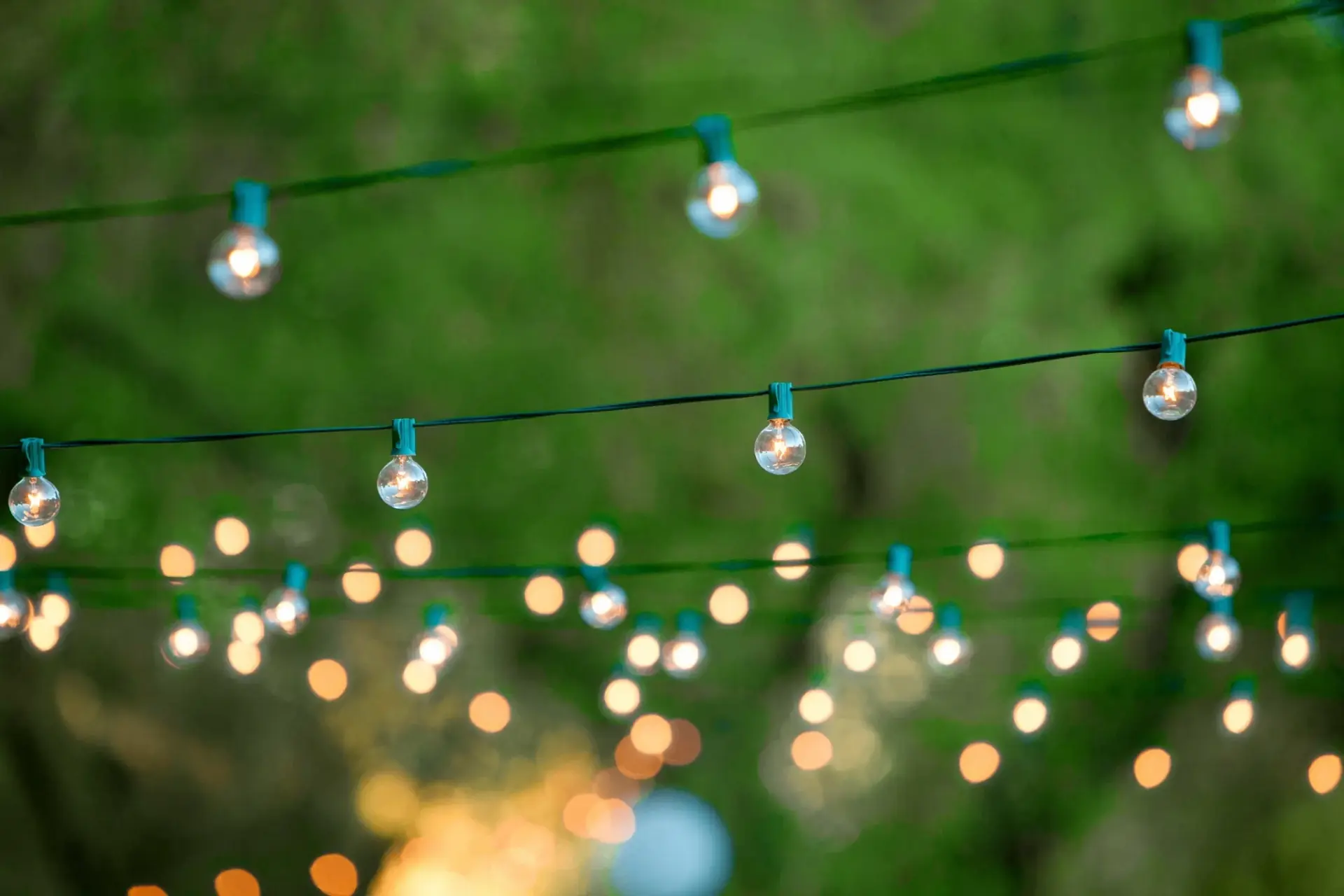 Bride and groom with wedding guests celebrating outdoors